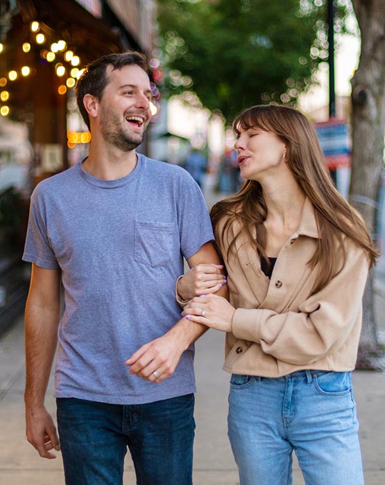 Young couple walking arm in arm.