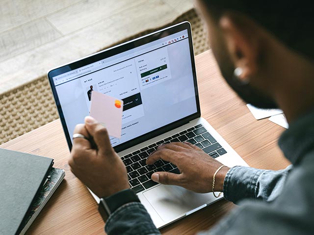 Man using a card to make an online purchase