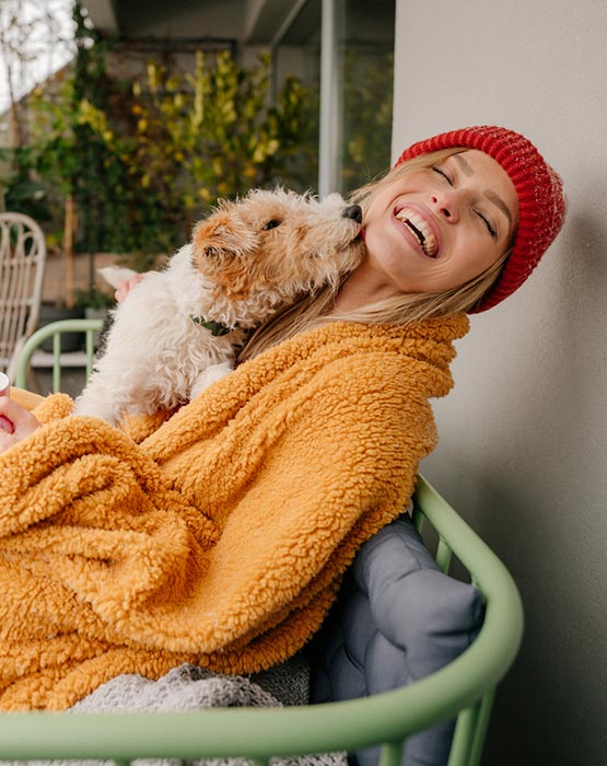 Woman with dog on her porch