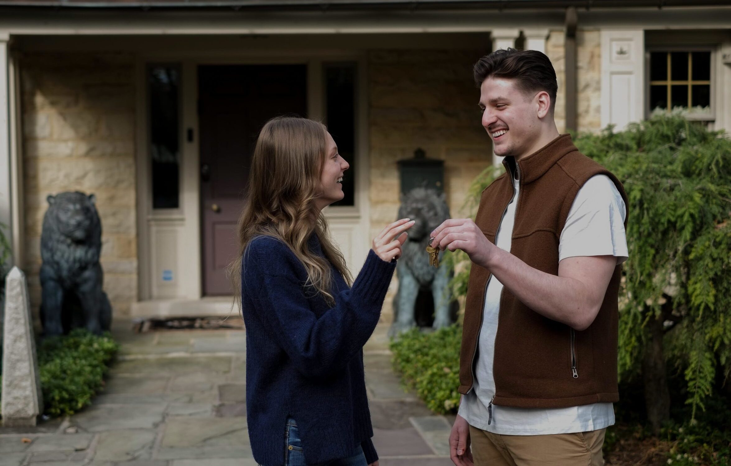 couple holding keys to a home