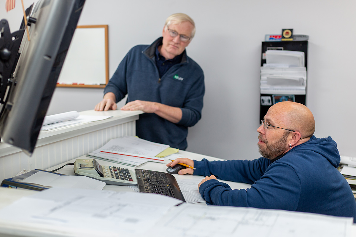 two men looking at a computer