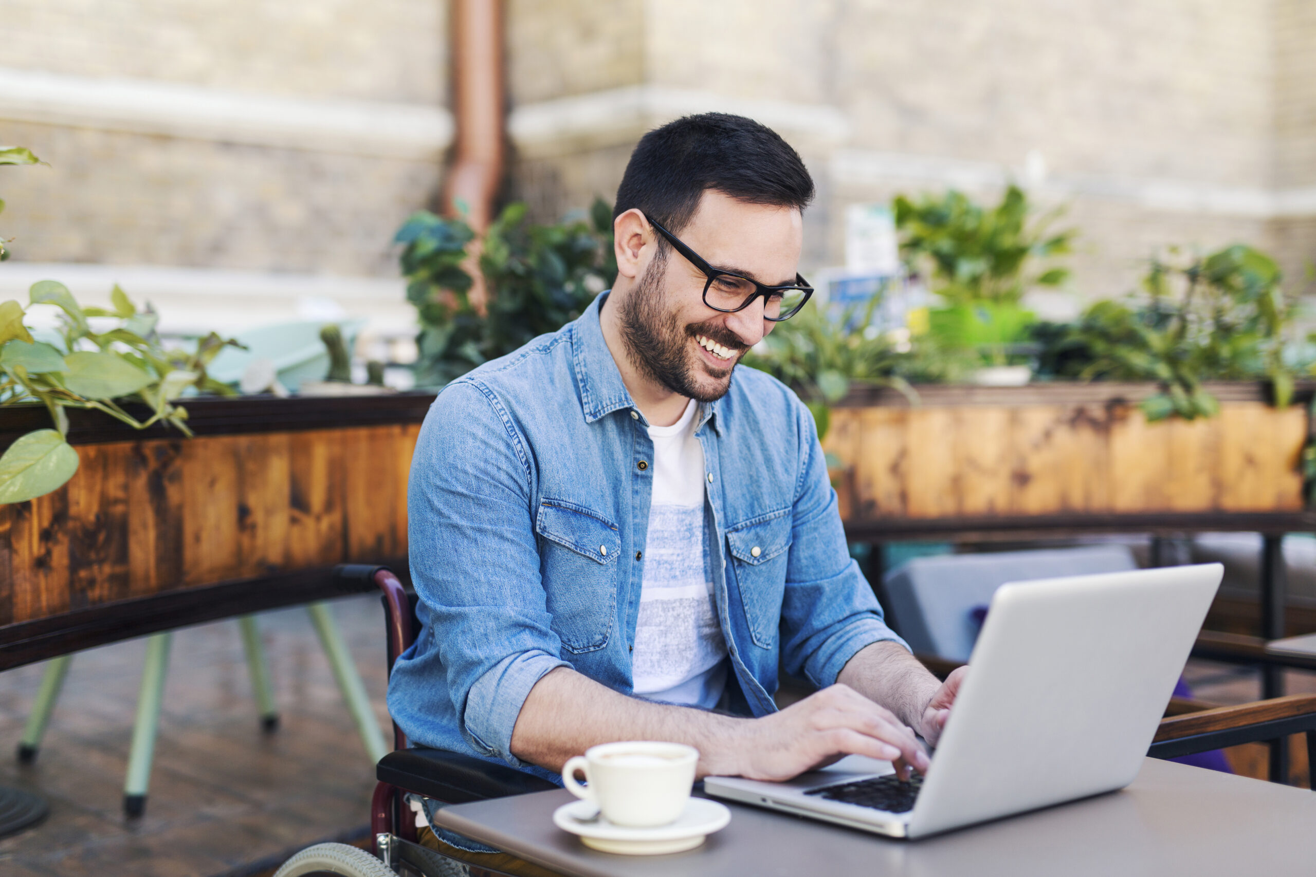 man at a coffee shop on his computer