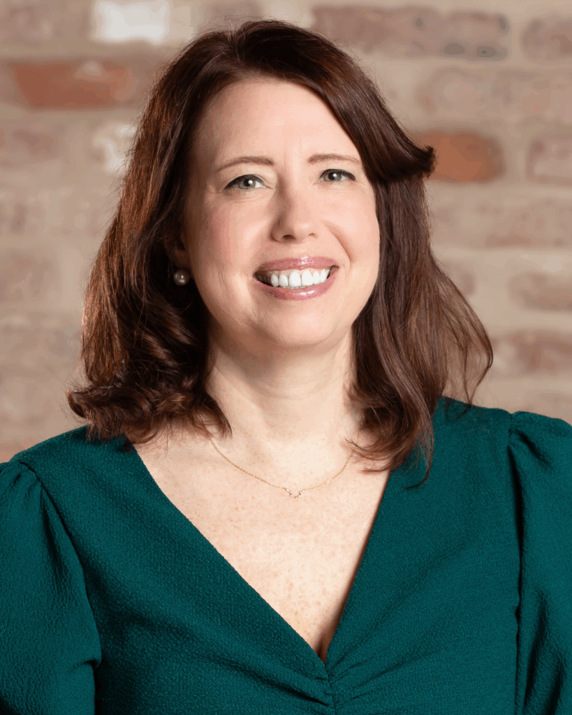 woman with brown hair and a green dress