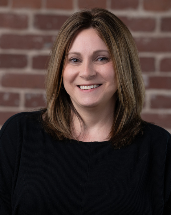 brown haired woman wearing a black sweater
